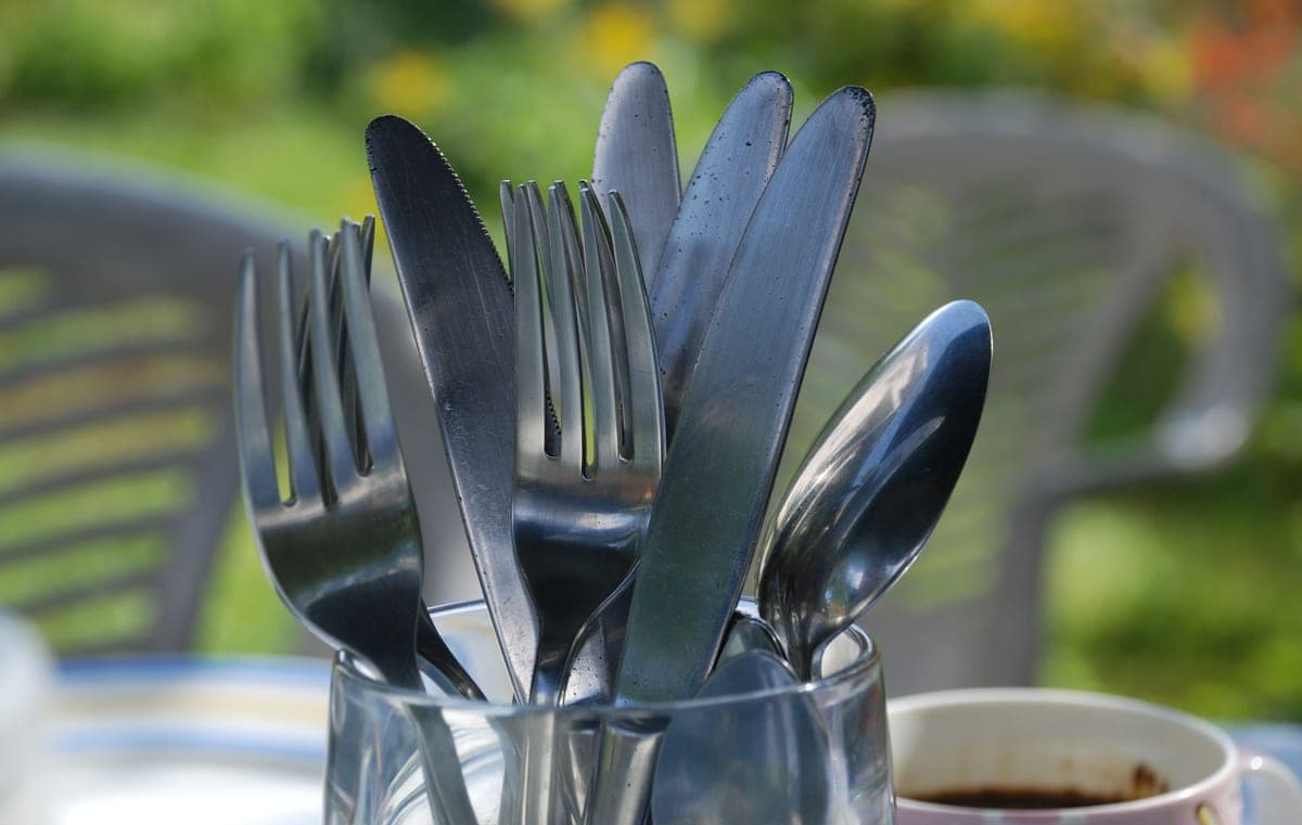 Forks, knives and spoons standing in a jar