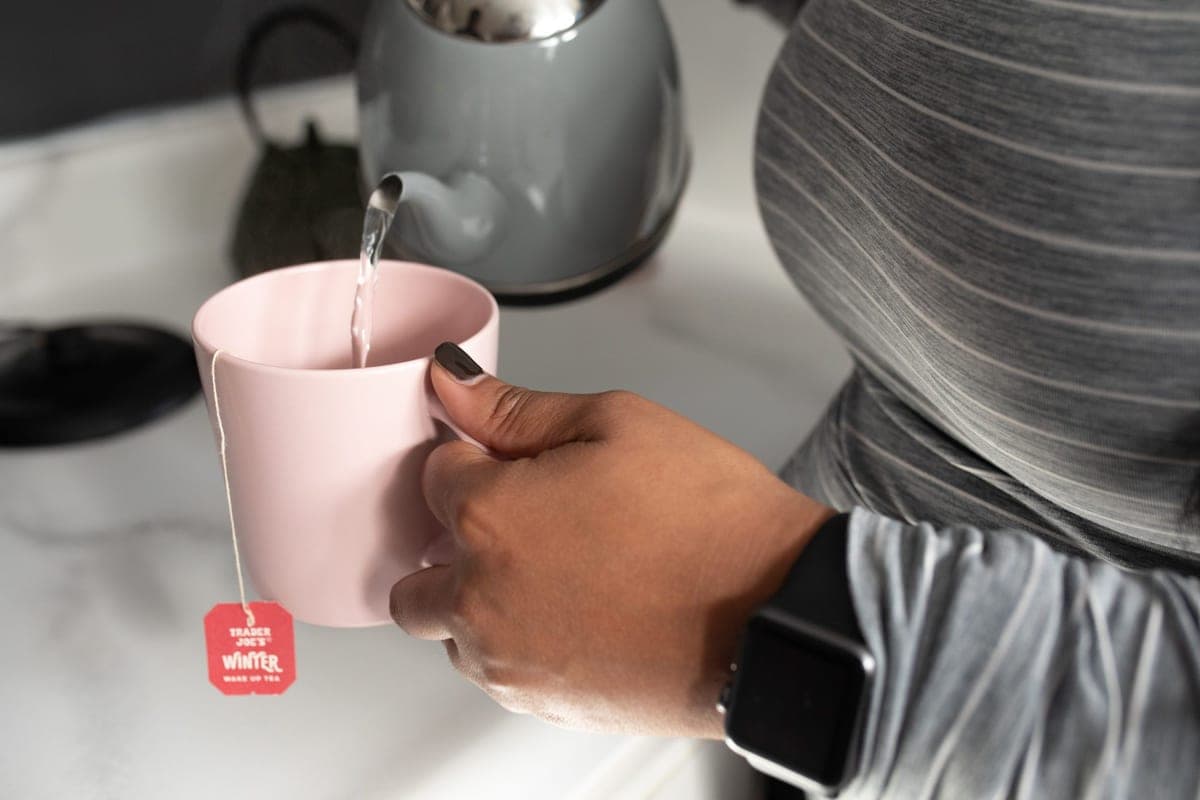 Tea being poured into a mug