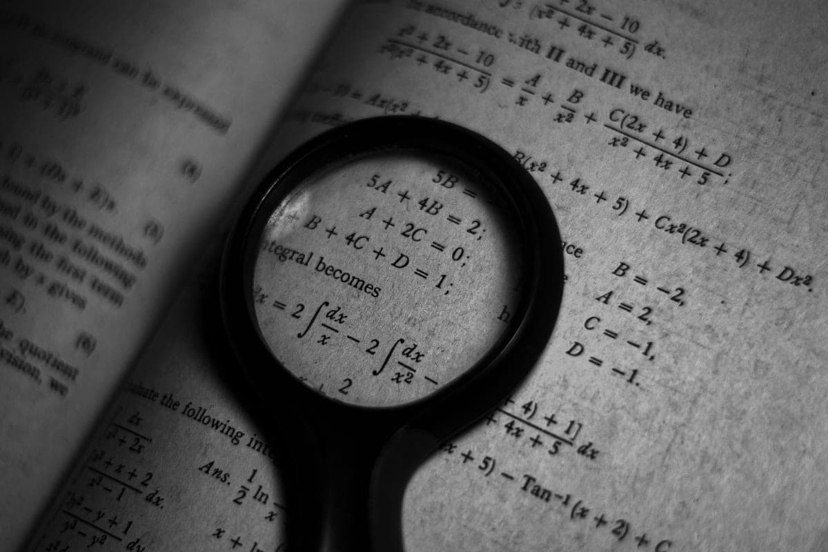 A magnifying glass resting on printed text