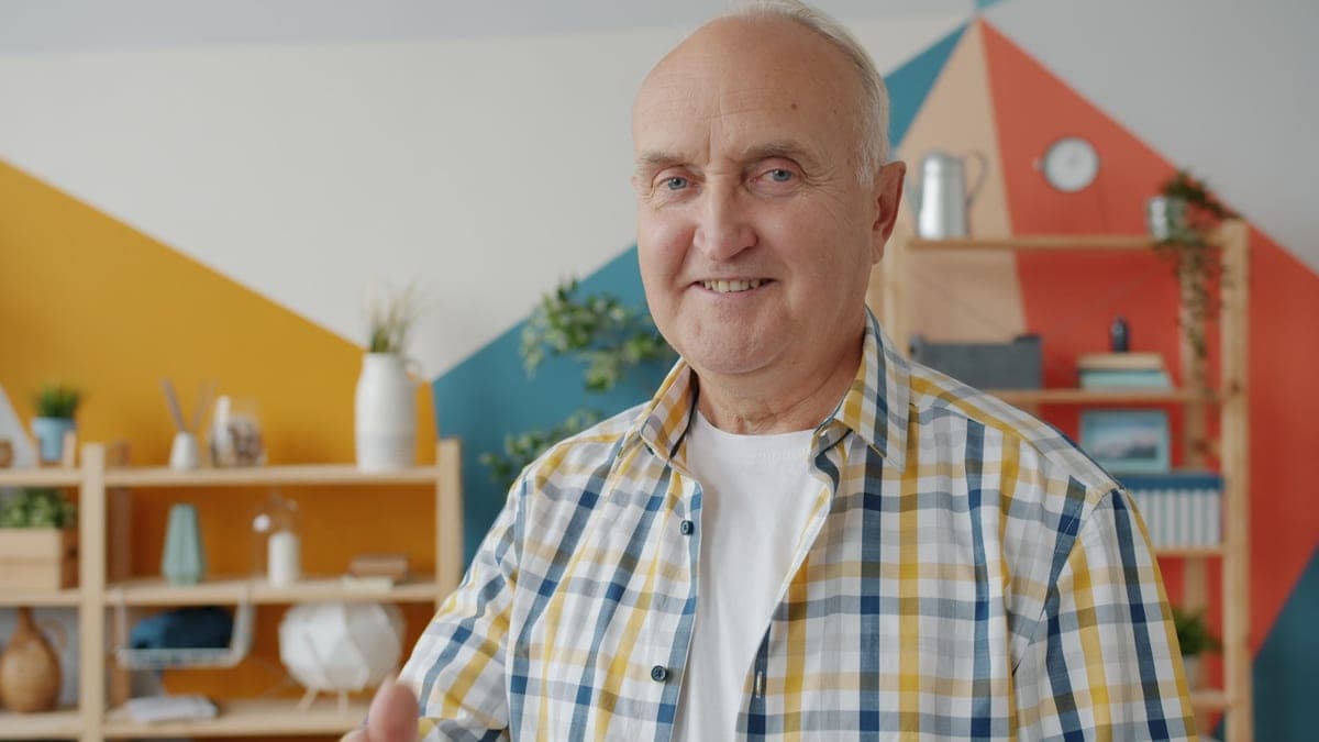 An older man smiling indoors
